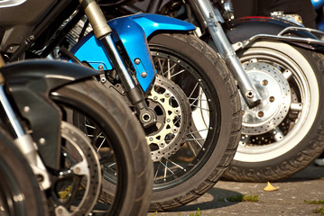 Fototapeta na wymiar Motorcycle wheel closeup. Motorcycle metal parts. Biker meeting in the city.