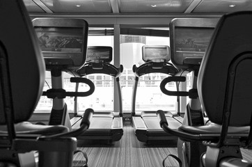 Staying fit with cardio fitness equipment like treadmills and bikes in gym or fitness center on...