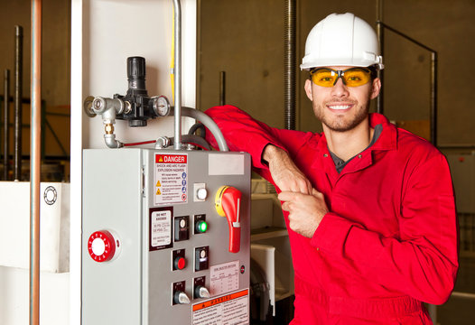 Technician standing next to electrical unit