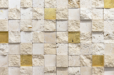 Natural stone mosaic tile with beige and gold squares.