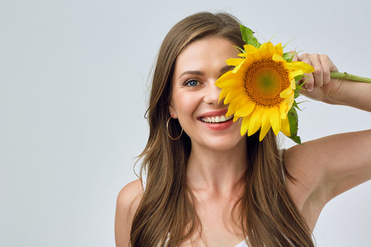 Happy Woman Holding Sunflower In Front Of Eye.