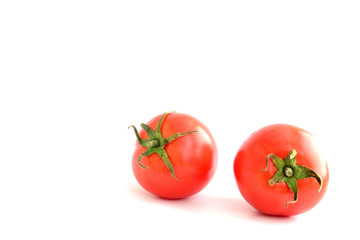 Two red tomatoes  on the white ground