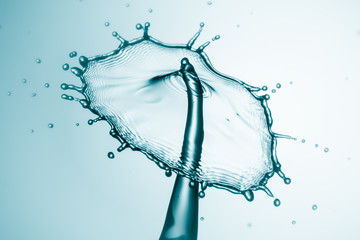 Water splash crown. Drop collision on blue background