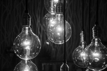 Black and white concept photo of big bulb lamps alight