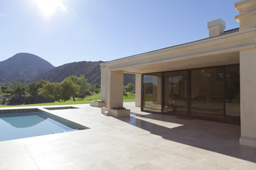 House exterior with pool and view of mountains