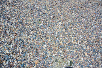 Small Oval Pebble Stones Background,Colorful pebbles on the coast,Small pebble Colorful beach.colorful small pebble and stone for background texture.