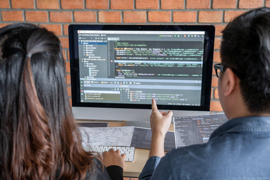 Programmers cooperating at Developing programming and website working in a software develop company office, writing codes and typing data code, Programming with HTML, PHP and javascript