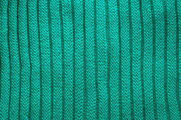 Knitting  in green.Knitted background. Knitted texture. Knitting pattern from wool.