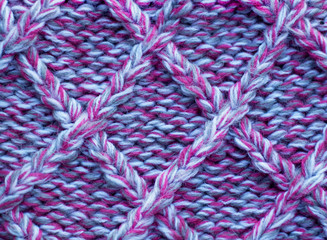 Knitting  in pink and gray melange.Knitted background. Knitted texture. Knitting pattern from wool.