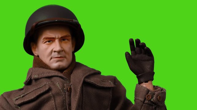 stop motion of toy soldier hello with the hand on green screen