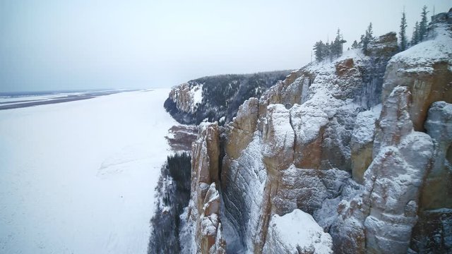 Snow-covered rocks and woods in Siberia