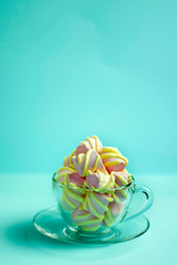 Top view of the pastel marshmallows on caps a color background. Minimal style.