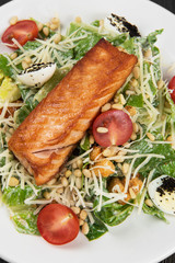 Grilled salmon caesar salad with croutons, parmesan, pine nut and quail egg
