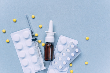 medical flat lay on blue background with spray pills and other components for treatment.fight the crown virus.COVID-19