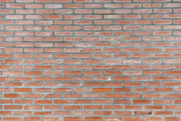 Obraz premium old obsolete orange brick wall with gray cement stained background texture nobody.