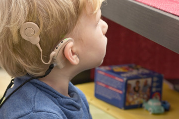 Boy With A Hearing Aids And Cochlear Implants