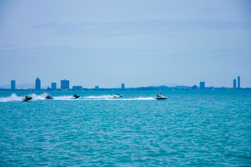 group of tourists sailing on jet skis off the coast Near Pattaya in Thailand,group of jet ski park at the beach on the morning at Larn island,Chonburi,Thailand