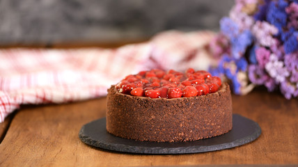 Delicious Homemade Chocolate Cheesecake Decorated With Cherry Sauce.