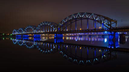 The Railway Bridge in Riga at night with beautiful reflections in Daugava river