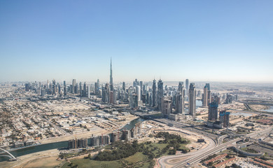 Aerial view of Dubai Downtown district as viewed from Dubai Creek and Safa park. Dubai, United Arab Emirates.