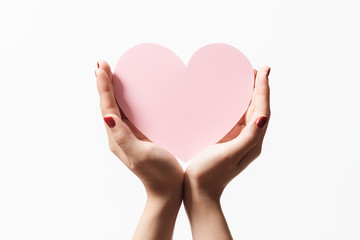 Close up women holding pink blank paper with heart shape on white background.
