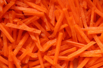 Photography of grated raw carrots pattern for food background