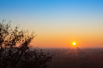 Munich cityscape during a beautiful colorful cold winter sunset in the city park. A view from Olympia Park hill.