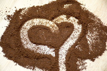 heart made of coffee beans on wooden background