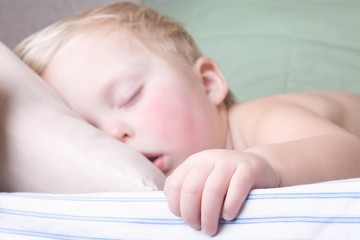 Baby boy lies sleeping