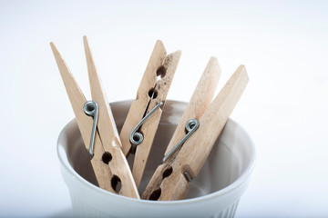 three wooden clothespins in a pot