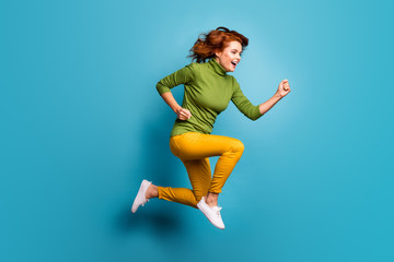 Fototapeta na wymiar Full length body size profile side view of nice attractive cheerful glad wavy-haired girl running jumping enjoying life isolated on bright vivid shine vibrant blue teal turquoise color background