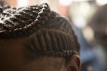 The top of a mans head with cornrows