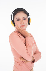 Cheerful Asian teenager wearing turtleneck and pants using wireless headphones enjoying listening to music studio portrait shot isolated on white background. Easy to cut out. Portrait orientation.