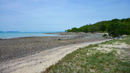 Stone courtyard on the public beach,Beautiful seascape with natural stone yard on beach against cloudy sky,Rocky shore at the seacoast with seascape and blue sky,