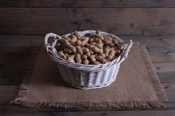 groundnuts on a wooden table in a basket.