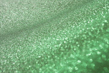Green sparkling abstract background festive concept Blur background