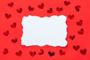 Blank white paper list with red shiny hearts on red background