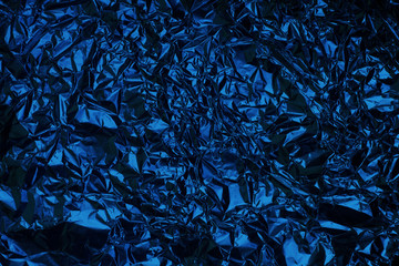 Classic blue crumpled foil texture background. Abstract pattern
