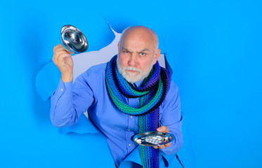 Fototapeta premium Bearded man holds different pills on plate. Medicine, treatments and healthcare. Man hands with pills. Man through hole holds different pills. Medicine pills on plate. Tablets in hand of patient.