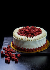 Tasty red velvet cake on dark background