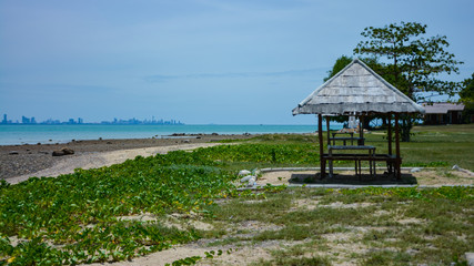 Fototapeta premium wooden cottage beside the sea,Wooden pavilion by the sea with blue sky. Gazebo for resting.