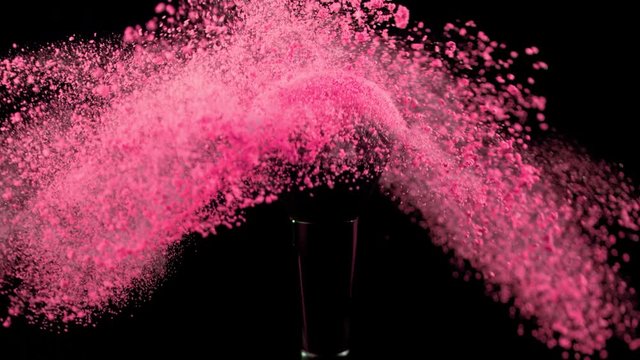 Super slow motion of makeup brush with falling powder, black background. Filmed on high speed cinema camera, 1000fps.