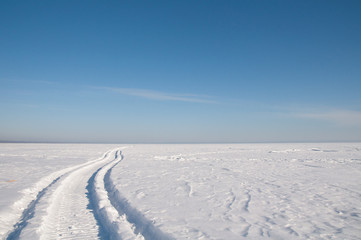 Fototapeta na wymiar Footprints in the snow, frost, sunny weather.