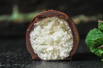 candy coconut in chocolate (tasty and healthy sweets dessert) menu concept. background. top view. copy space
