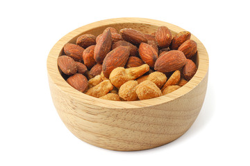 Close up salted almonds and salted cashew nuts in wooden bowl isolated on white background with clipping path.
