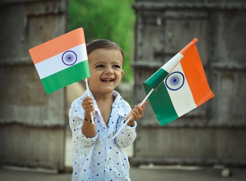 beautiful view of Indian kid with Indian flag in his hand