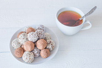 Homemade energy sweet balls-sweets with dried apricots, raisins, dates, prunes, walnuts, cashews and coconut. Indian vegetarian desserts.