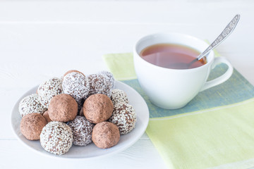 Homemade energy sweet balls-sweets with dried apricots, raisins, dates, prunes, walnuts, cashews and coconut. Indian vegetarian desserts.