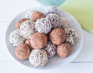 Homemade energy sweet balls-sweets with dried apricots, raisins, dates, prunes, walnuts, cashews and coconut. Indian vegetarian desserts.