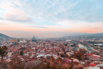 Tbilisi, Georgia, 15 December 2019 - travel card of cableway cabin on the background of cityview at the sunset